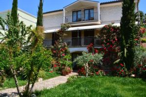 a house with flowering plants in front of it at Velia Mare in Numana