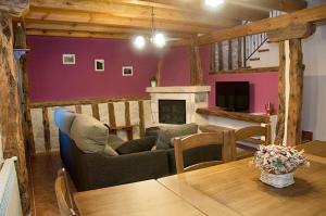 a living room with a couch and a table at Casa Rural EL VALLECILLO in Valle de Tabladillo