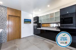 a kitchen with black and white appliances and a sign that says clean and sale at Luxury 47 in Albufeira
