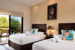 Postel nebo postele na pokoji v ubytování Villas Palmar Holbox