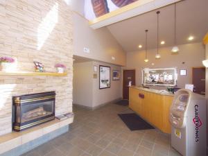 a waiting room with a fireplace in a hospital at Best Maple Inn - Drayton Valley in Drayton Valley