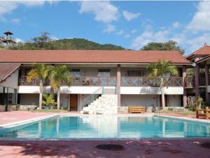 a resort with a swimming pool in front of a building at Amami Resort Bashayamamura - Vacation STAY 81977 in Amami