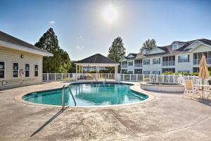 a swimming pool in a yard with a house at Myrtle Beach Townhouse in Legends Golf and Resort! in Myrtle Beach