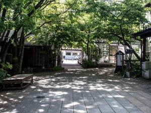 a patio with a bench and trees in a yard at DOT DOT HOUSE NAGANO Traditional Japanese house - Vacation STAY 82102 NAGANO - Vacation STAY 82102 in Nagano