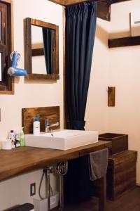 a bathroom with a sink and a mirror at DOT DOT HOUSE NAGANO Traditional Japanese house - Vacation STAY 82102 NAGANO - Vacation STAY 82102 in Nagano