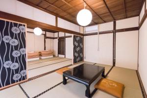 a living room with a table and a bench at DOT HOUSE NAGANO Traditional Japanese house - Vacation STAY 82102 in Nagano