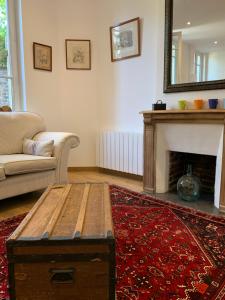 a living room with a table and a fireplace at CHEZ PAUL in Honfleur