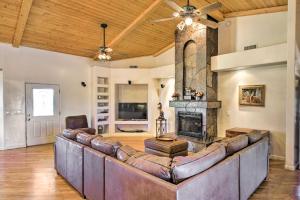 a living room with a couch and a fireplace at Luxe Scottsdale Home with Horse Stables and Pool! in Scottsdale