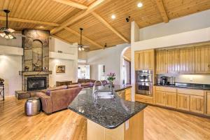 an open kitchen and living room with a fireplace at Luxe Scottsdale Home with Horse Stables and Pool! in Scottsdale