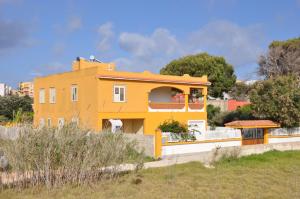 a yellow house with an orange roof at La Fenice in Lampedusa