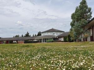 a field of flowers in front of a house at Eqynox Hotel in Vitry-le-François