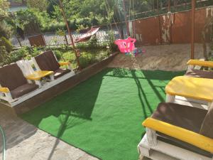 ズラトグラッドにあるGuest Rooms Profirovの緑の芝生のある裏庭(椅子付)、プール