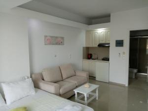 a living room with a couch and a table at Steven in Vasiliki