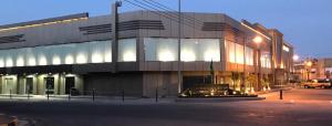 a large building on a city street at night at Najran Hotel in Najran