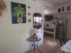 a living room with a table and a refrigerator at Casa del Solar Centro Cozumel - Wifi gratuito Fibra Óptica 200 Mbps in Cozumel