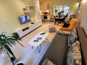 a living room with a couch and a table at Apartments Ida & Miljenko in Kaštela