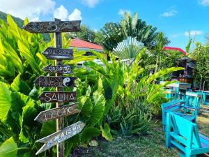 a bunch of signs in front of a resort at Gites titanse, la cabane dans l arbre in Cadet +18 photos
