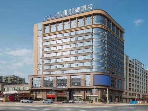 a large building with cars parked in front of it at Kyriad Mavelous Hotel Shantou Gurao in Shantou