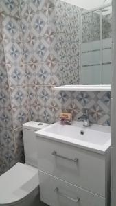 een badkamer met een toilet, een wastafel en een spiegel bij Appart'hotel de la Mairie in Morlaix