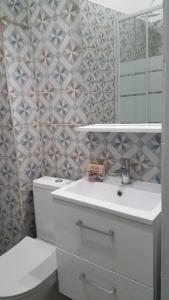 a bathroom with a toilet and a sink and a mirror at Appart'hotel de la Mairie in Morlaix