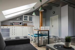 a kitchen and living room with a table and chairs at Gościniec Rajec in Rajcza