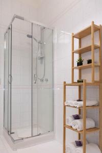 a bathroom with a shower with a glass shower stall at Gaia14 in Salerno