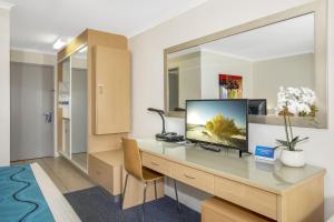 a room with a desk and a computer on it at Best Western Airport 85 Motel in Brisbane