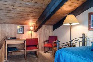 a bedroom with a desk and a bed and a lamp at Ptarmigan House in Steamboat Springs