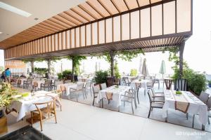a restaurant with tables and chairs on a patio at Apartments Garden view in Cliff Resort & Residences in Mui Ne