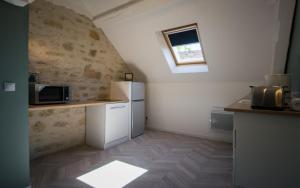 A kitchen or kitchenette at Gîte Mise au Vert