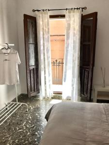 a bedroom with a bed and a window with a gate at Casa Nadal in Concud