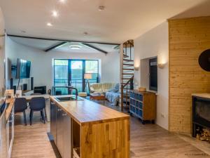 a kitchen and living room with a fireplace at Palanga Dome apartment in Palanga