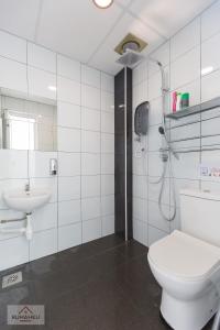 a bathroom with a shower and a toilet and a sink at Rumahku Express, Georgetown, Penang in George Town