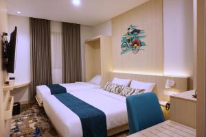 Letto o letti in una camera di Cordia Hotel Yogyakarta - Hotel Dalam Bandara