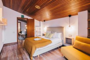 a bedroom with a bed and a couch at Barandi Urbasa in Olazagutía