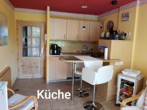 a kitchen with a table and chairs in a room at Appartement Lotte in Kiel +27 photos