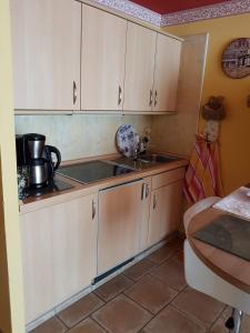 a kitchen with white cabinets and a sink at Appartement Lotte in Kiel