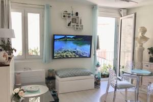 a living room with a tv on the wall at ANTINEA in Cassis