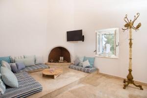 a living room with two couches and a tv at White Rose in Kalithies