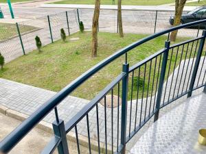 a blue metal railing on a staircase with a street at Palanga Dome apartment in Palanga