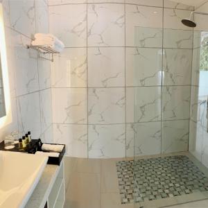 a bathroom with a shower with a tub and a sink at Marina Point Bay Resort in Panglao +119 photos