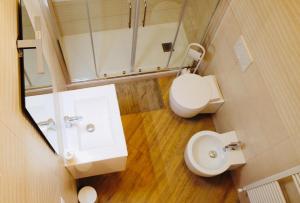 a bathroom with a sink and a toilet and a mirror at IL NIDO IN CENTRO in La Spezia +4 photos