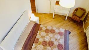 a bedroom with a bed with a quilt on it at IL NIDO IN CENTRO in La Spezia