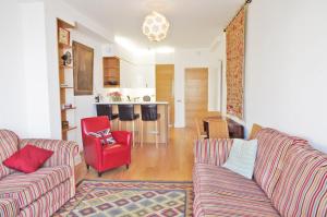 a living room with two couches and a red chair at Super Nice Clerkenwell Home in London