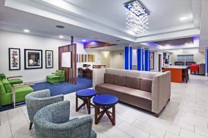 a lobby with a couch and chairs and a table at Holiday Inn Express New Orleans East, an IHG Hotel in New Orleans