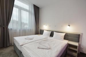 Postel nebo postele na pokoji v ubytování Hotel Roztocze