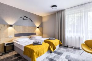 Posteľ alebo postele v izbe v ubytovaní KRISTINA Willa & Spa