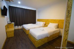 Postel nebo postele na pokoji v ubytování Mesra Boutique Hotel
