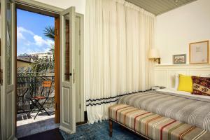 a bedroom with a bed and a window at Market House - An Atlas Boutique Hotel in Tel Aviv