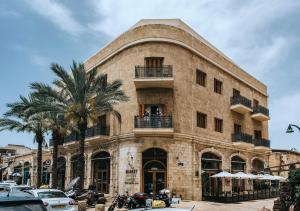 a large building with a clock on the front of it at Market House - An Atlas Boutique Hotel in Tel Aviv